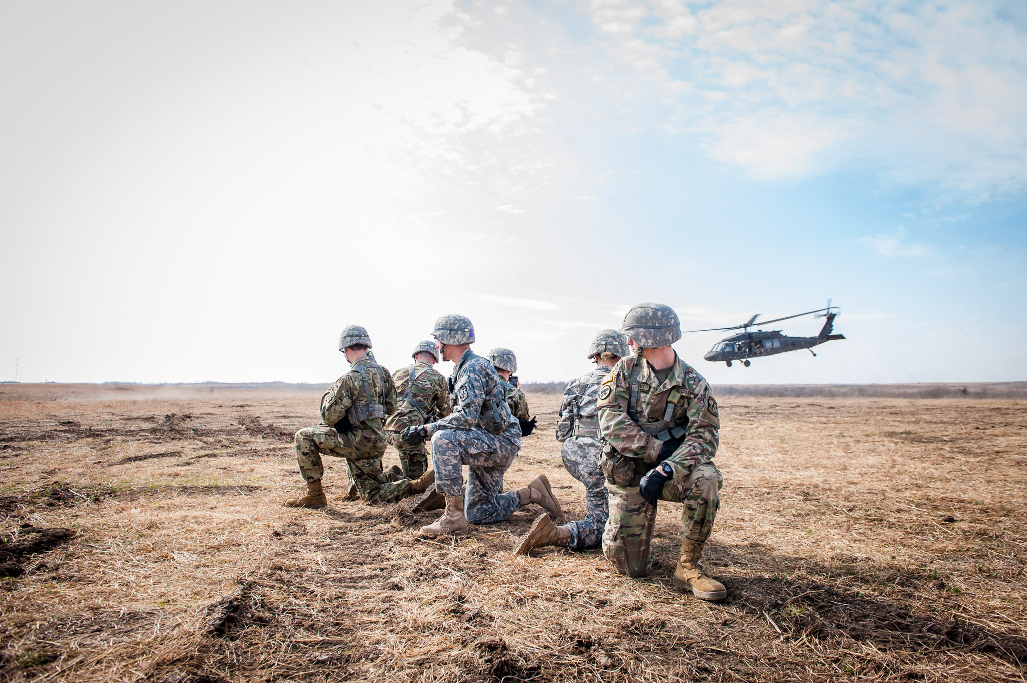 Six ROTC students watching a helicopter taking off.